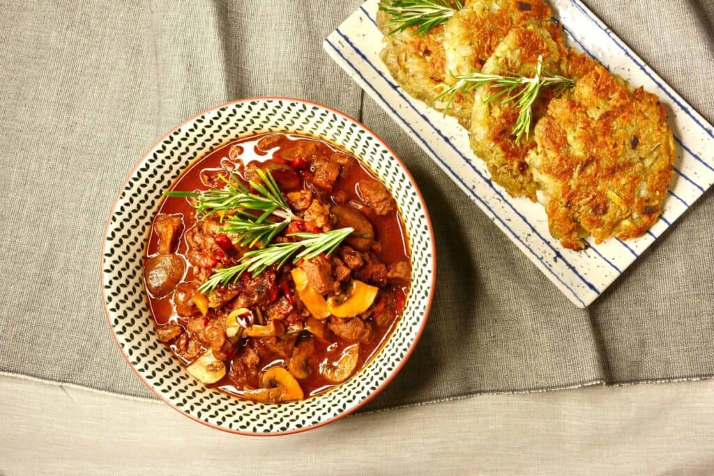 Rezept für veganes Gulasch mit Sojaschnetzeln, Champignons und knusprigen Kartoffelpuffern